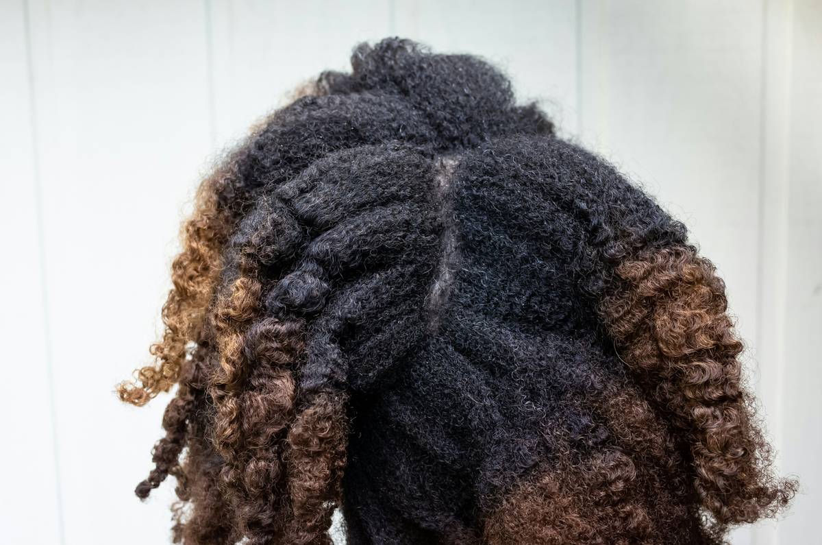 Woman with loose, voluminous hair twists showcasing Gentle Styling results